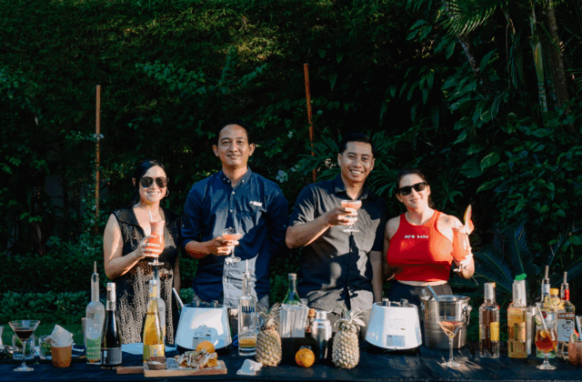 Tourist relaxing and sipping a tropical cocktail at Astagina Resort Legian Bali