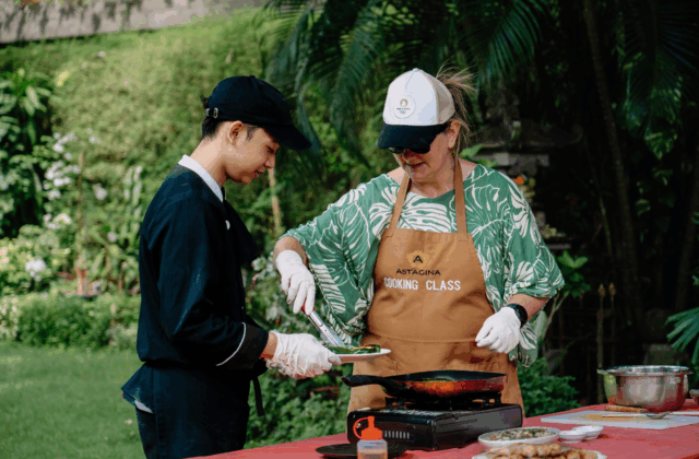 Guests learning to prepare authentic traditional Balinese dishes during the cooking class at Astagina Resort.
