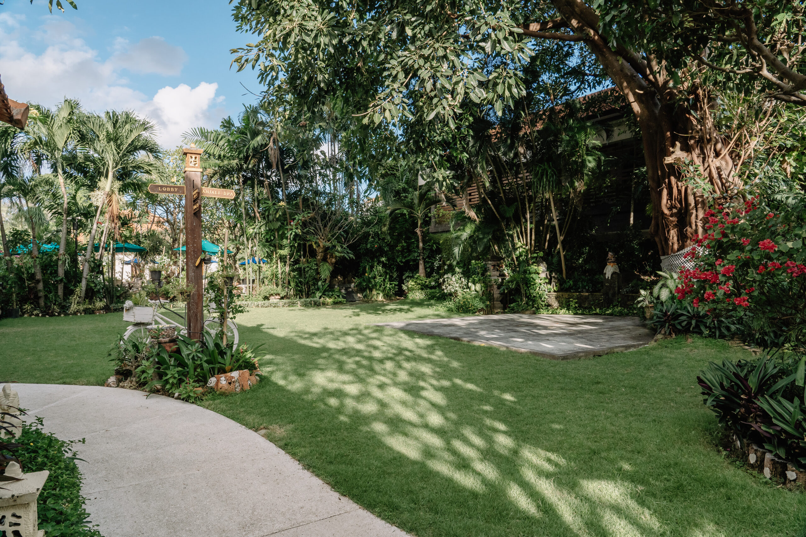Kids Friendly Lush garden at tropical resort with palm trees