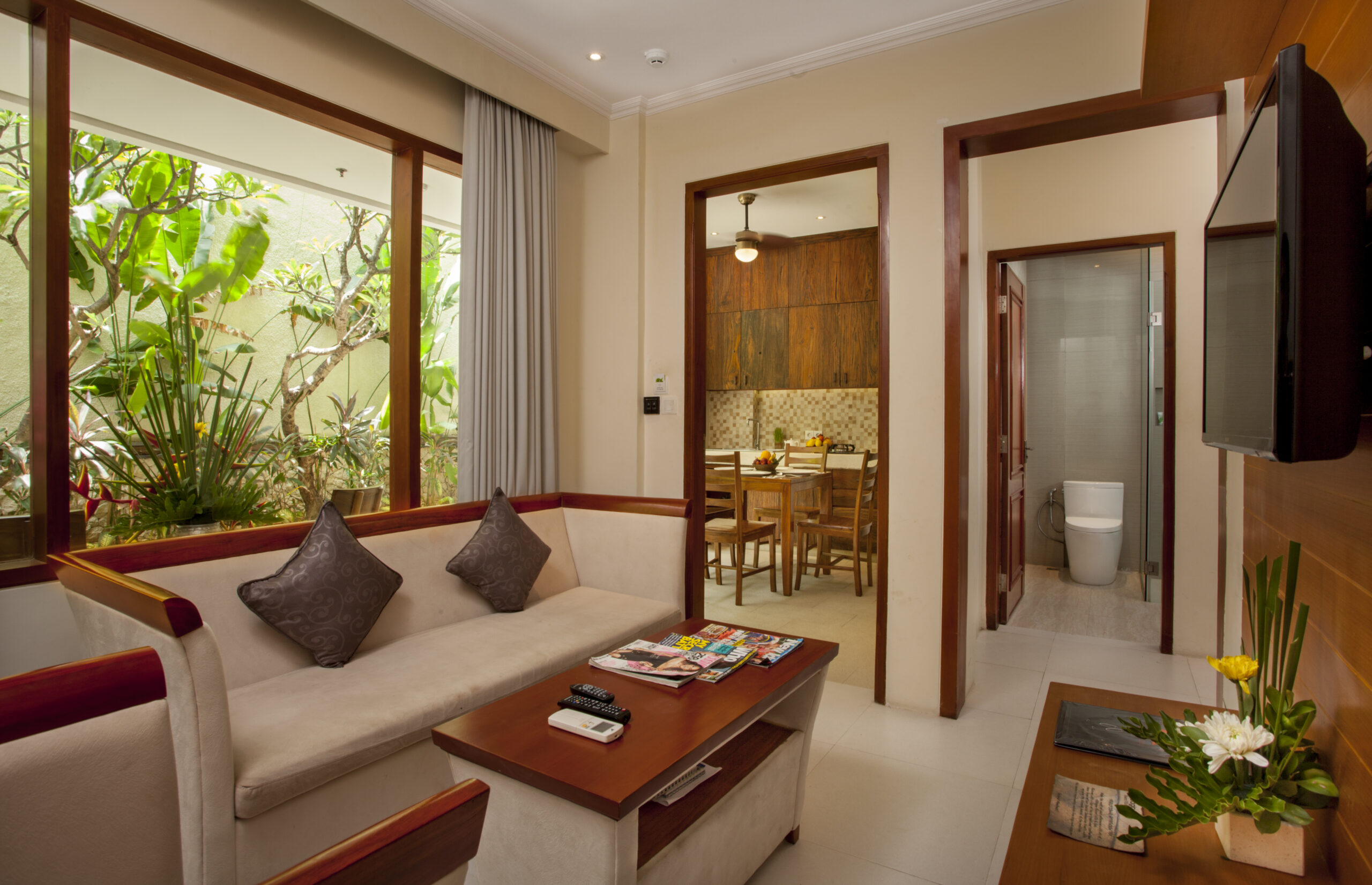 Cozy villa bedroom with warm teak wood and modern amenities