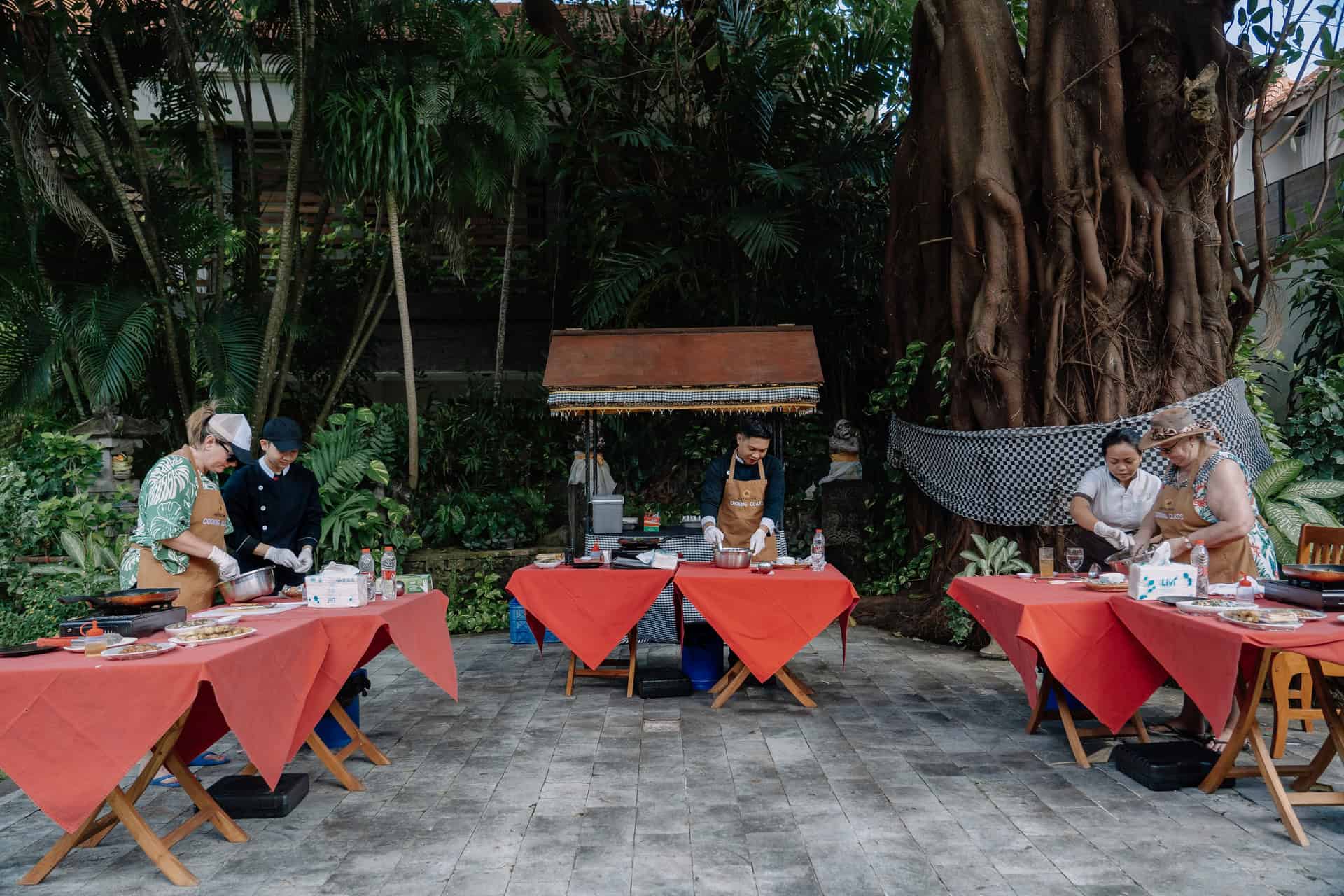Family cooking class activity in garden setting at Astagina Resort Villa and Spa Legian family resort Bali
