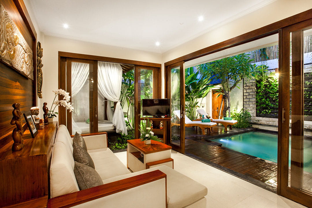 Spacious living room with pool view at Astagina Resort Legian family accommodation