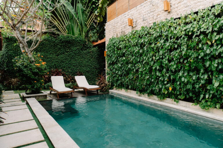 Private pool villa at Astagina Resort Legian with tropical garden and outdoor lounge area