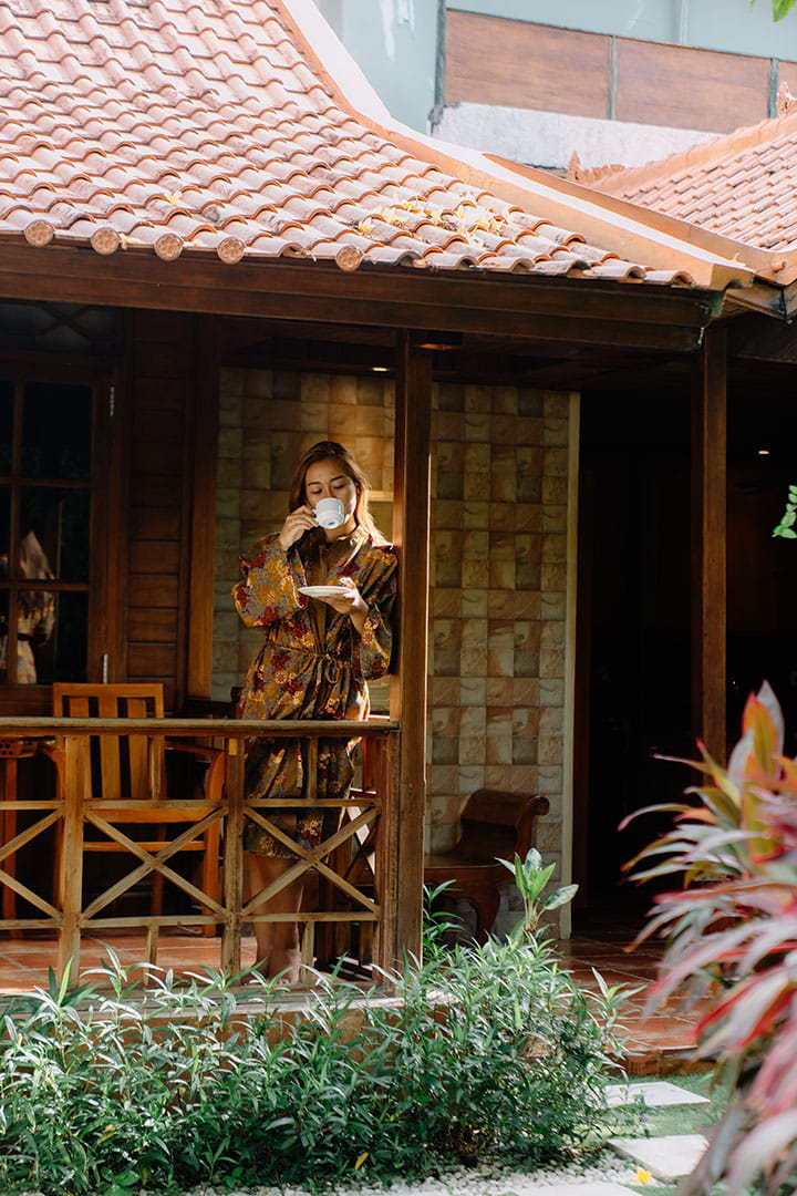 Guest relaxing in wooden villa room at Astagina Resort Legian Bali