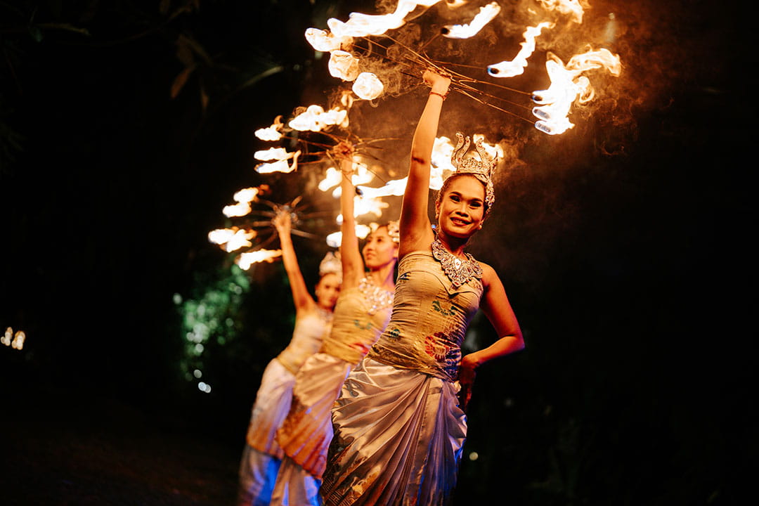 Fire dance performance at a garden wedding venue in Bali creating a lively evening atmosphere